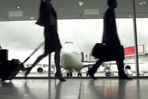 People walking through airport, silhouette (focus on aeroplane)