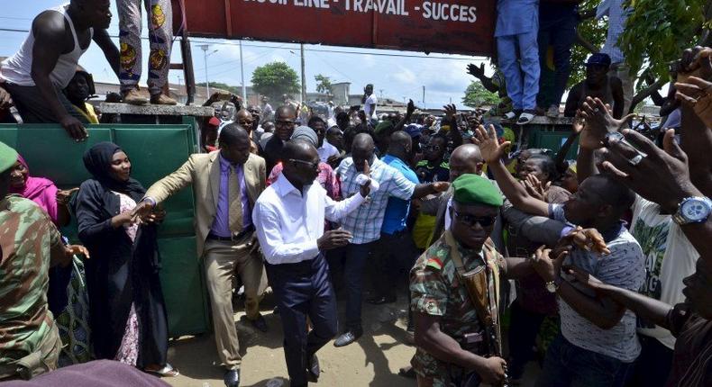 Benin Presidential candidate Patrice Talon (C, in white) arrives at a polling station during presidential elections in Cotonou, Benin, March 20, 2016. REUTERS/Charles Placide Tossou