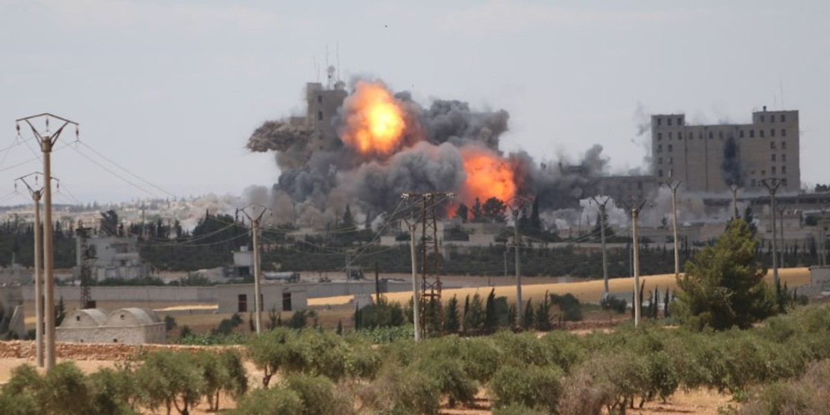 Smoke and flame rise after what fighters of the Syria Democratic Forces (SDF) said were U.S.-led air strikes on the mills of Manbij where Islamic State militants are positioned, in Aleppo Governorate