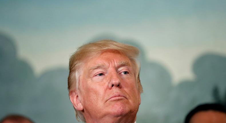 President Donald Trump pauses to listen to a question after signing a memorandum calling for a trade investigation of China, Monday, Aug. 14, 2017, in the Diplomatic Reception Room at the White House in Washington.