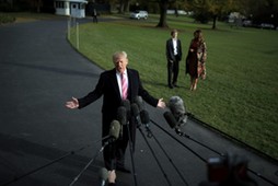 U.S. President Donald Trump talks with the reporters as First Lady Melania Trump and her son Barron 