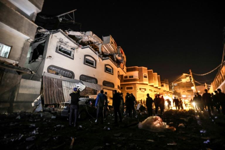 Palestinians inspect the damaged house of Islamic Jihad leader Baha Abu Al-Ata after the deadly attack