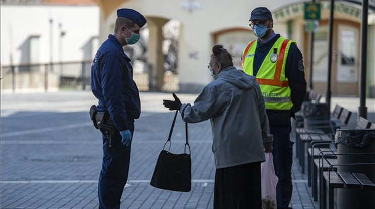 Idős járókelővel beszélget egy rendőr Egerben, a kijárási korlátozás kezdetének napján /Fotó: MTI-Komka Péter