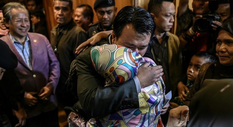 Malaysians freed by Pyongyang made an emotional return Friday after landing at Kuala Lumpur international airport