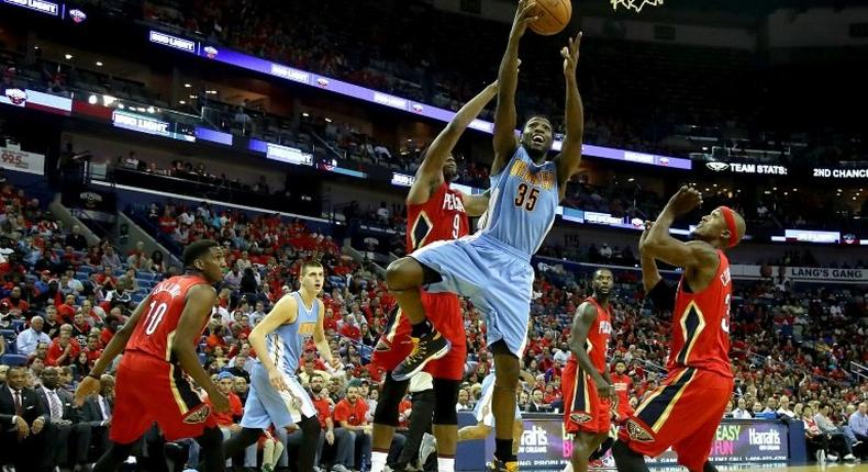 Malik Beasley of the Denver Nuggets shoots over Terrence Jones of the New Orleans Pelicans at the Smoothie King Center in New Orleans, Louisiana