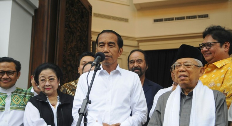 Indonesia's Joko Widodo (C), who has won a second term as president, spoke to reporters with his running mate Ma'ruf Amin (R) in Jakarta three days before the official results were announced