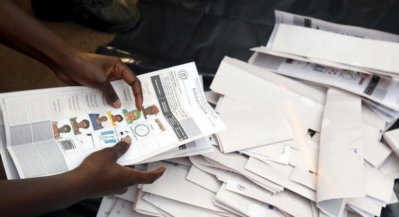 Electoral officials count votes at a polling station in Uganda's capital Kampala February 18, 2016 as voting closes. REUTERS/James Akena