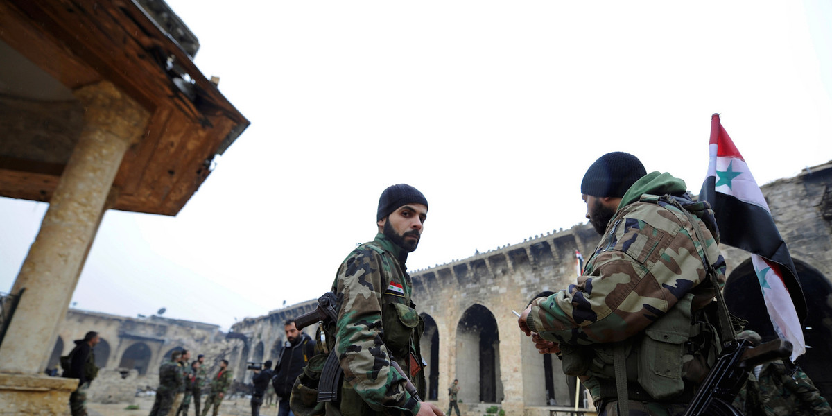 Forces loyal to Syria's President Bashar al-Assad stand inside the Umayyad mosque, in the government-controlled area of Aleppo, during a media tour, Syria December 13, 2016.