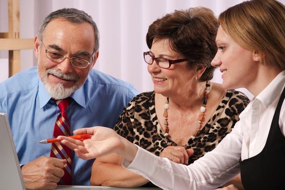 Senior couple meeting with agent or advisor