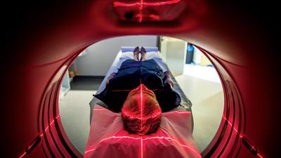 Patient lying inside a medical scanner in hospital