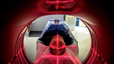 Patient lying inside a medical scanner in hospital