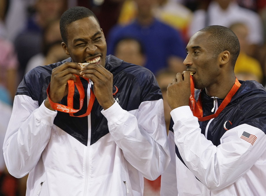 The United States National Team defeated Spain in the men's basketball finals at the 2008 Olympic Games in Beijing. Here, along with teammate Dwight Howard, Bryant playfully bites into his gold medal.