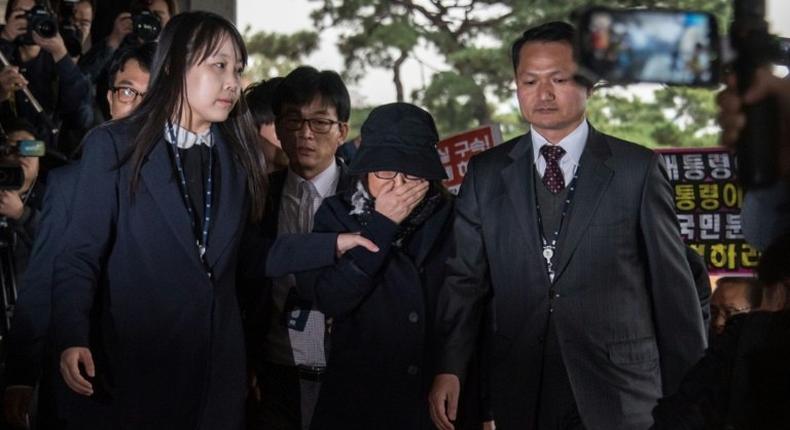 Choi Soon-Sil (C) is escorted to the Seoul Central District Prosecutor's Office, on October 31, 2016