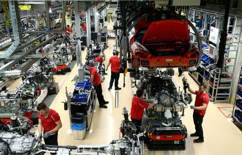 FILE PHOTO: Employees of German car manufacturer Porsche assemble sports cars at the Porsche factory