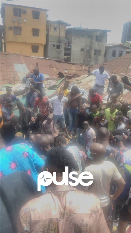 Local residents at the scene of the collapsed building (Pulse) 