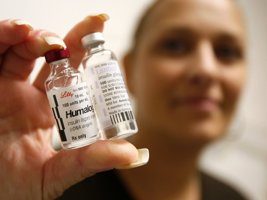 A Type 1 diabetes patient holds up bottles of insulin.