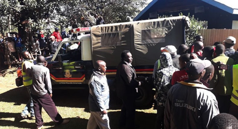 File image of Police Officers and members of the public at a crime scene. Shock as 3 guards hacked to death in Mutomo, Kitui County