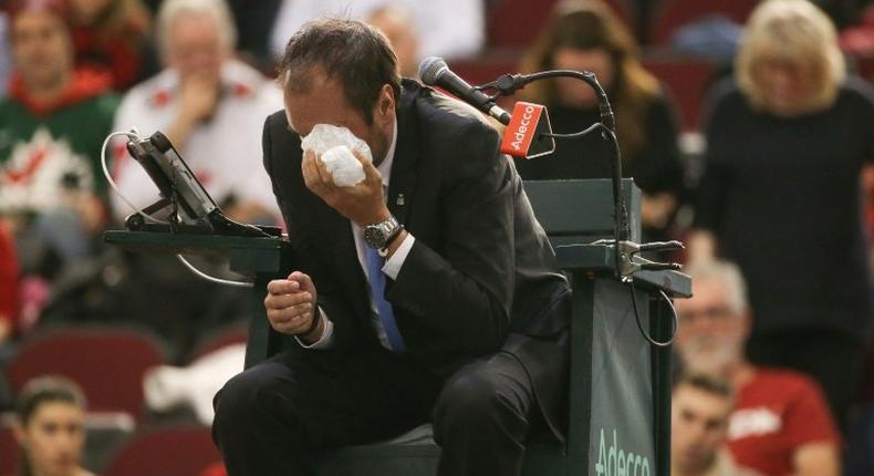Chair umpire Arnaud Gabas reacts to getting hit in the eye with a ball hit by Denis Shapovalov of Canada on February 5, 2017