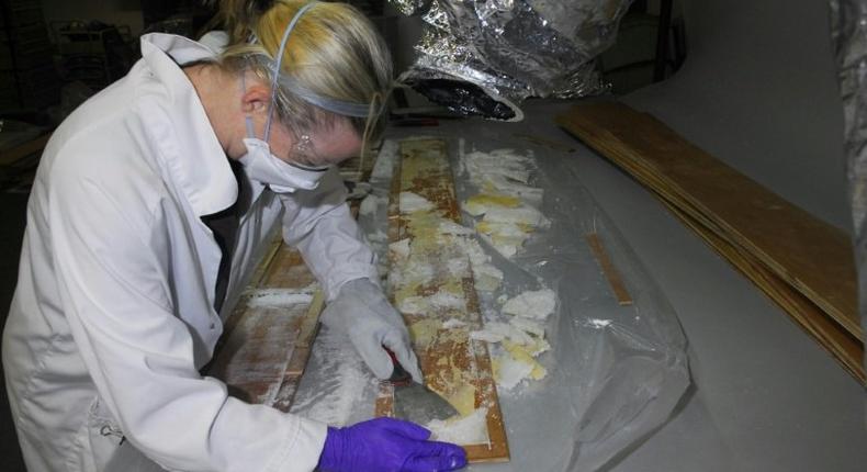 Crystal methamphetamine is removed from planks of wood at a warehouse in Nunawading, east of Melbourne, Australia, where it was hidden in 70 boxes of floorboards shipped from China