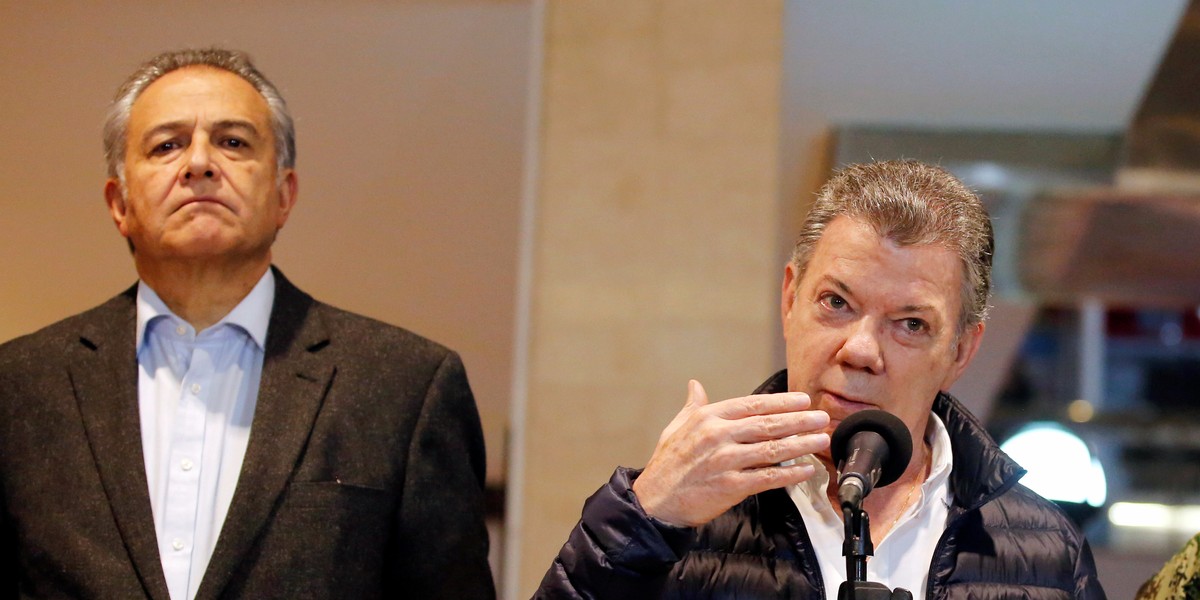 Colombian President Juan Manuel Santos, center, next to Vice President Oscar Naranjo, in Bogota, June 17, 2017.