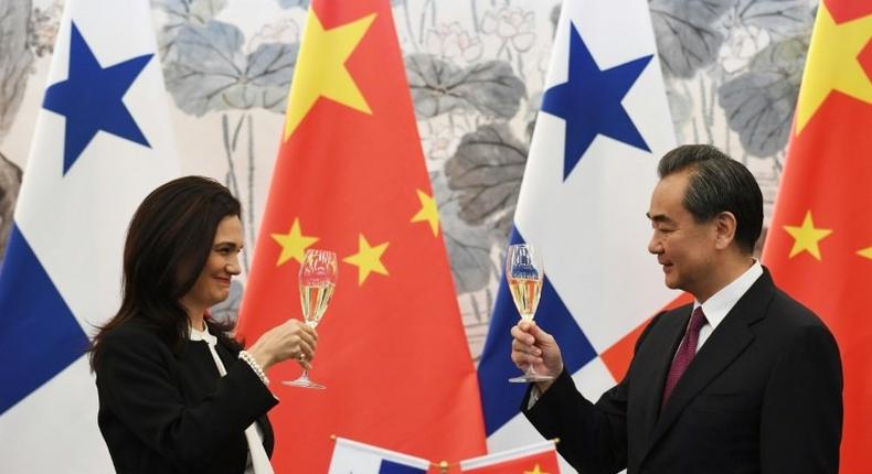 Panama's Vice President and Foreign Minister Isabel de Saint Malo (L)and Chinese Foreign Minister Wang Yi drink a toast after signing a joint communiqué on establishing diplomatic relations, in Beijing on June 13, 2017