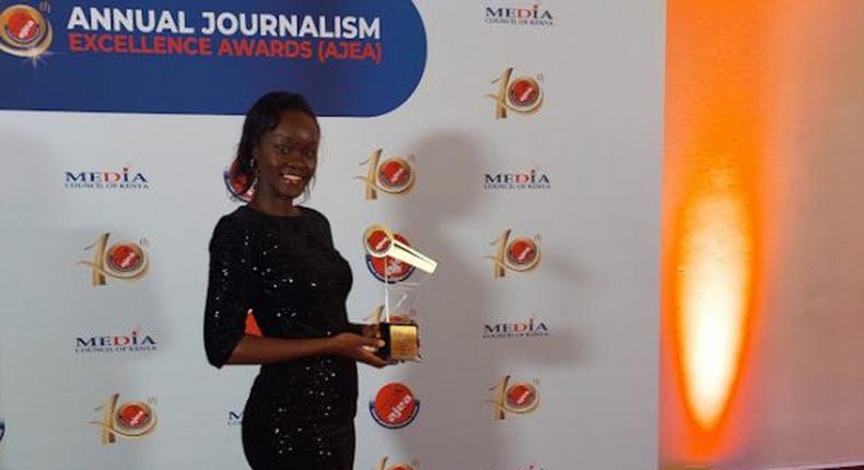 Brenda Kerubo posing with an award