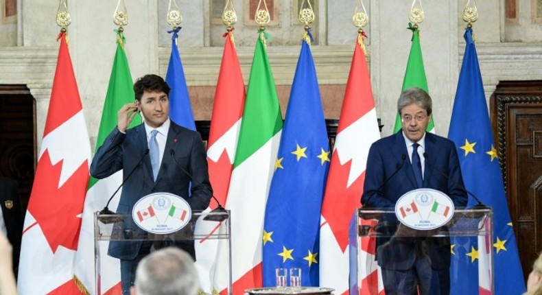 Italy's Paolo Gentiloni (right) said the importance of transatlantic ties should not lead Europe to renounce 'fundamental principles such as our commitments against climate change'