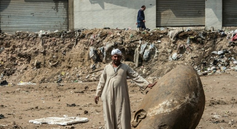 The head of a pharaonic statue that dates back over 3,000 years found in a muddy pit of what is now a sprawling Cairo suburb