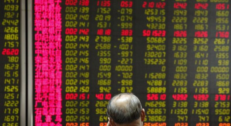 A man watches a board showing stock prices at a brokerage office in Beijing, China, July 6, 2015.   REUTERS/Kim Kyung-Hoon