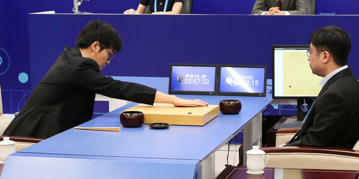 Chinese Go player Ke Jie puts a stone against Google's artificial intelligence program AlphaGo during their first match at the Future of Go Summit in Wuzhen