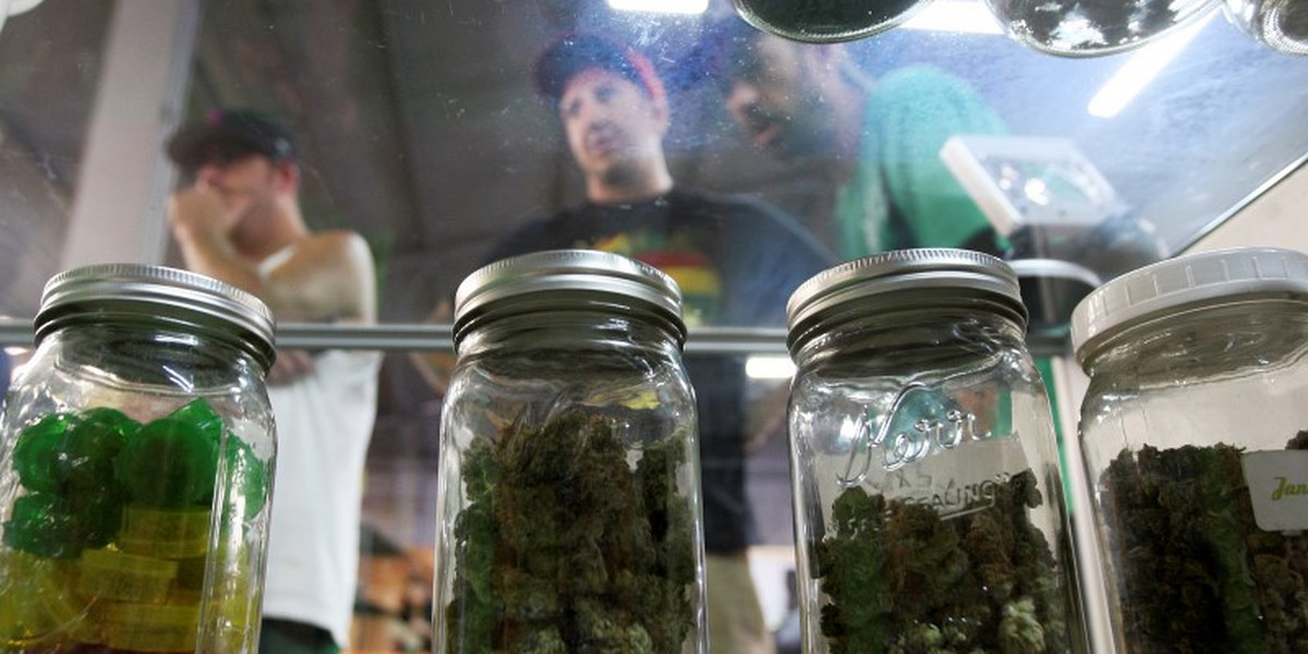 People look at jars of marijuana at the medical marijuana farmers market in Los Angeles.