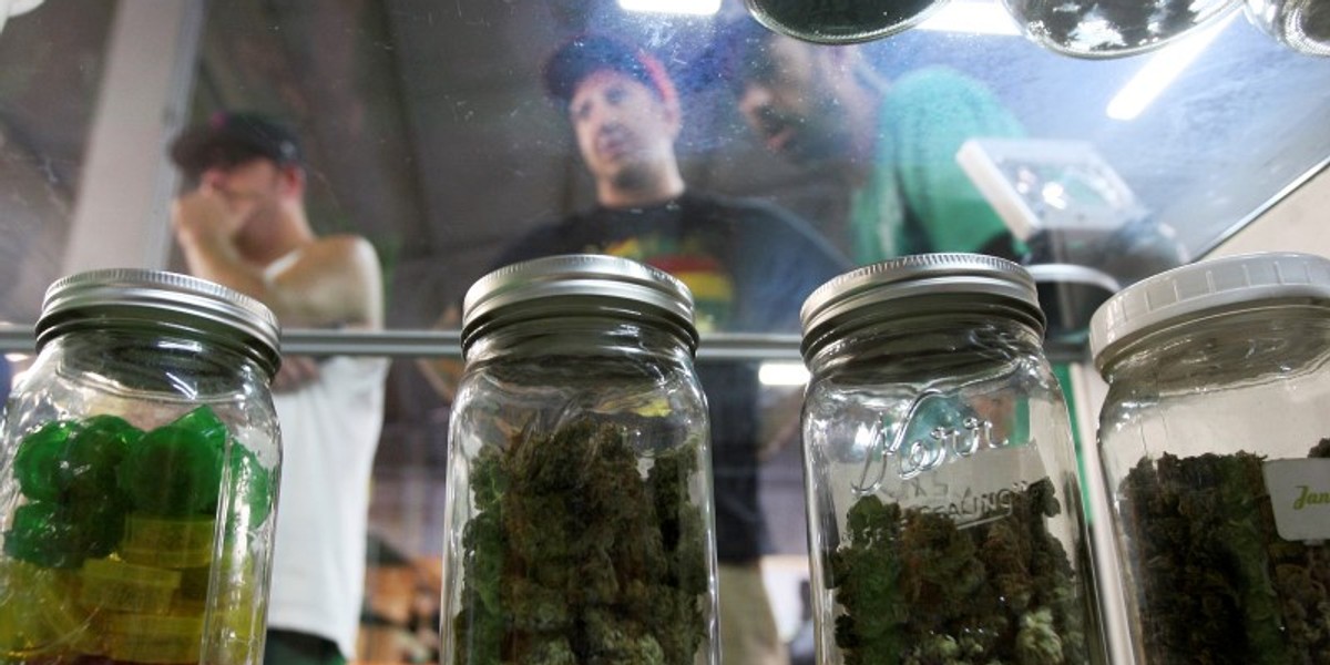 People look at jars of marijuana at the medical marijuana farmers market in Los Angeles.