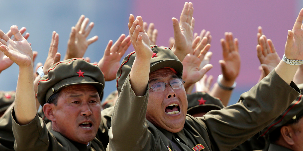 Korean War veterans shout slogans to North Korean leader Kim Jong-un during a parade in Pyongyang July 27, 2013.