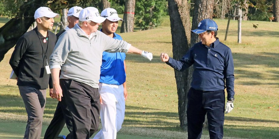 Visiting US President Donald Trump gives Japanese Prime Minister Shinzo Abe a "fist bump" as they played golf, accompanied by World No. 4 golfer Hideki Matsuyama at the Kasumigaseki Country Club in Japan.