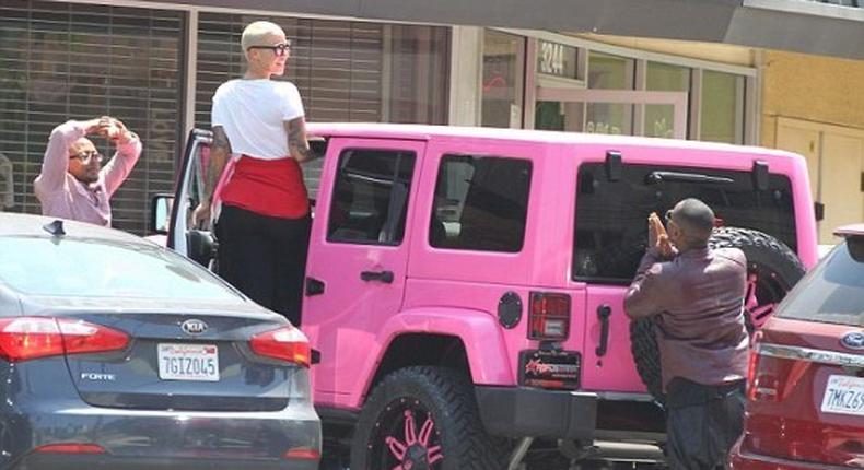 Amber Rose posing by her pink jeep