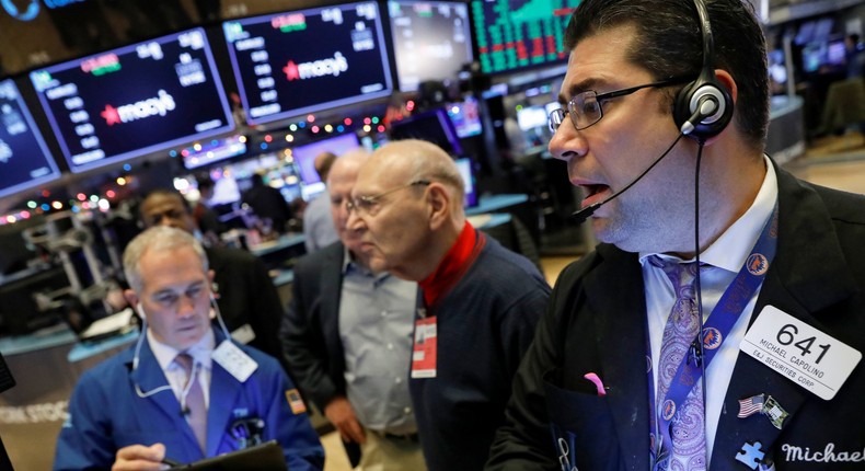 FILE PHOTO: Traders work on the floor at the New York Stock Exchange (NYSE) in New York, U.S., November 27, 2019. REUTERS/Brendan McDermid