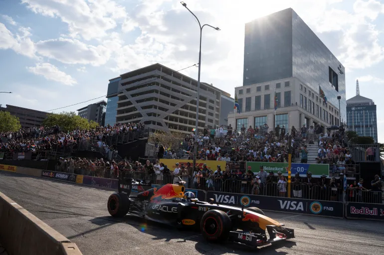 David Coulthard, a former Formula One driver, drives the Red Bull RB7 through the streets of the Sandton. [Ihsaan Haffejee/Reuters]