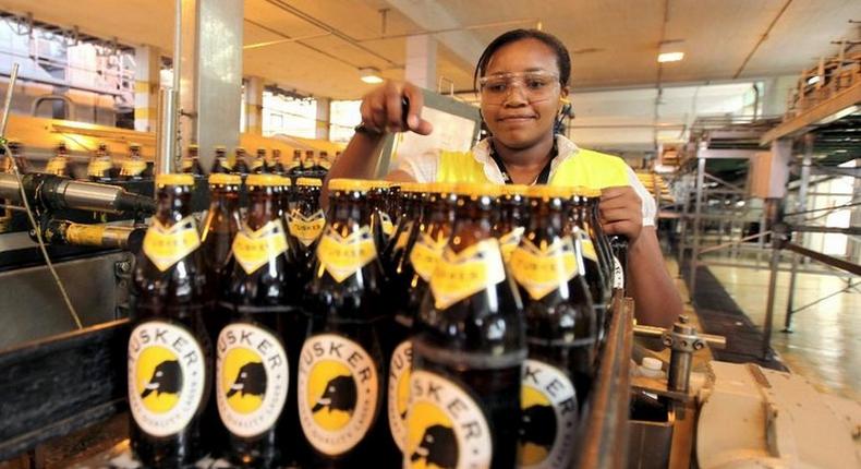 A file photo of an employee inspecting beer at an East African Breweries Ltd factory.