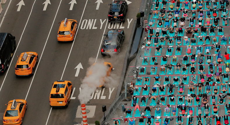 A yoga class being held in the Times Square district of New York during an annual Solstice event.