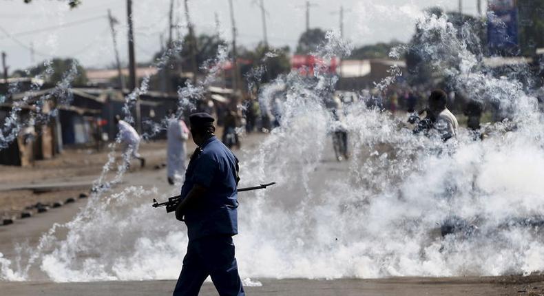 A policeman walks after throwing a teargas canister during a protest against Burundi President Pierre Nkurunziza and his bid for a third term in Bujumbura, Burundi, June 2, 2015. REUTERS/Goran Tomasevic