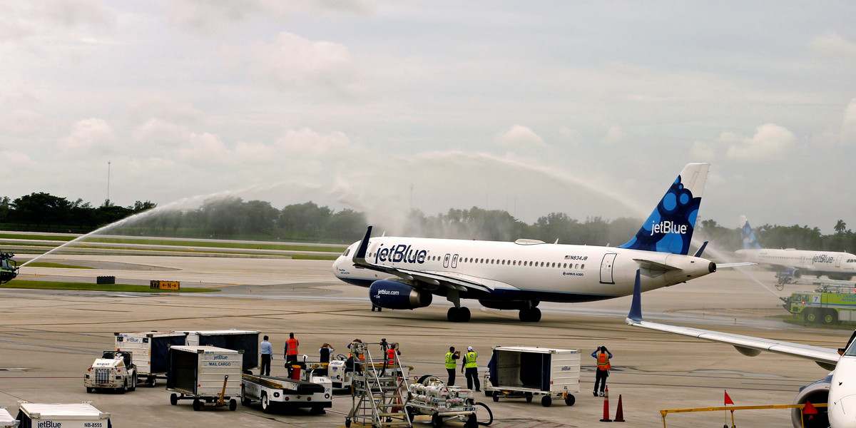 Water cannons are deployed as Jet Blue Flight 387 departs from Fort Lauderdale International Airport, for Santa Clara, Cuba, inaugurating the first regularly scheduled commercial flight between the US and Cuba in more than half a century, on August 31, 2016.
