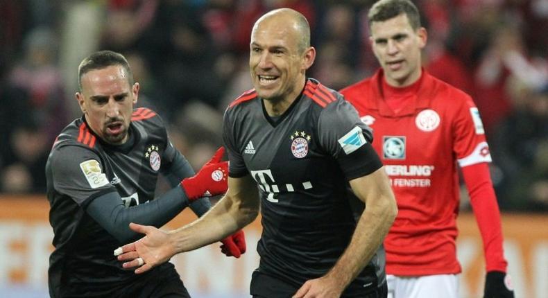 Bayern Munich's midfielder Arjen Robben celebrates scoring the 2-1 goal with Bayern Munich's midfielder Franck Ribery (L) during the German first division Bundesliga football match between FSV Mainz 05 and FC Bayern Munich December 2, 2016