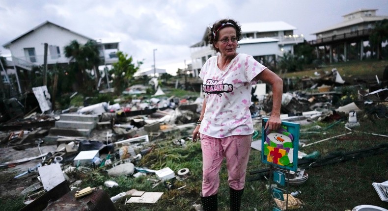 Jewell Baggett stands beside a Christmas decoration she recovered from the wreckage of her mother's home, as she searches for anything salvageable from the trailer home her grandfather had acquired in 1973 and built multiple additions on to over the decades, in Horseshoe Beach, Florida, after the passage of Hurricane Idalia, Wednesday.Rebecca Blackwell/Associated Press