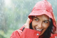 Woman smiling while out in rain