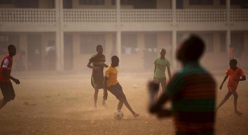 Boys play soccer on a field of a school used as an electoral centre at the end of the presidential and legislative elections, in the mostly muslim PK5 neighbourhood of Bangui, Central African Republic, February 14, 2016. x