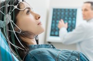 Charming young woman undergoing electroencephalography