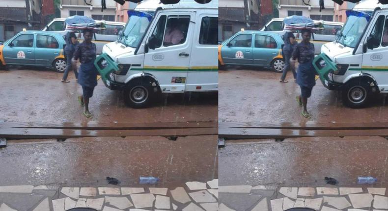 Umbrella seller refuses to use one of her umbrellas to protect herself against rain