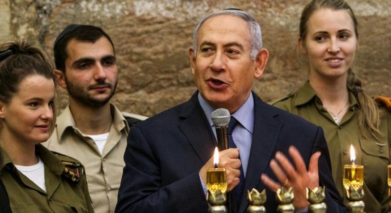 Israeli Prime Minister Benjamin Netanyahu, seen here during a menorah-lighting ceremony with Israeli soldiers for Hanukkah, has hailed majority backing at the UN for condemning militant group Hamas even though a US draft resolution failed to pass