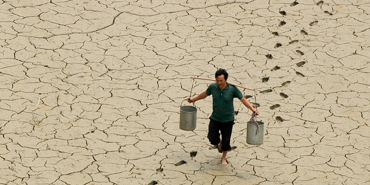 A farmer on a dried-up pond on the outskirts of Baokang in central China's Hubei province.