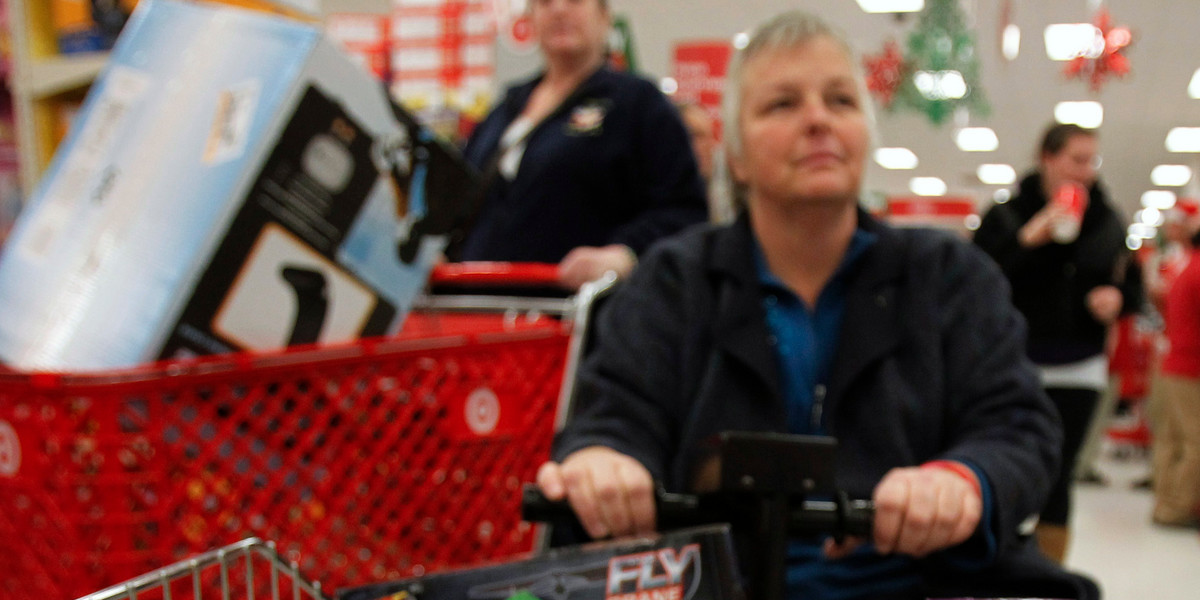A woman rides a motorized shopping cart through a Target store on the shopping day dubbed "Black Friday"
